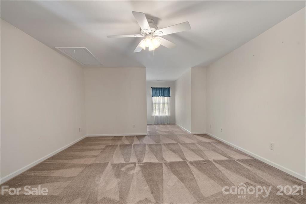 257 Garnet Court Fort Mill, SC 29708 - Photo 16 of 43 a view of an empty room with a chandelier fan
