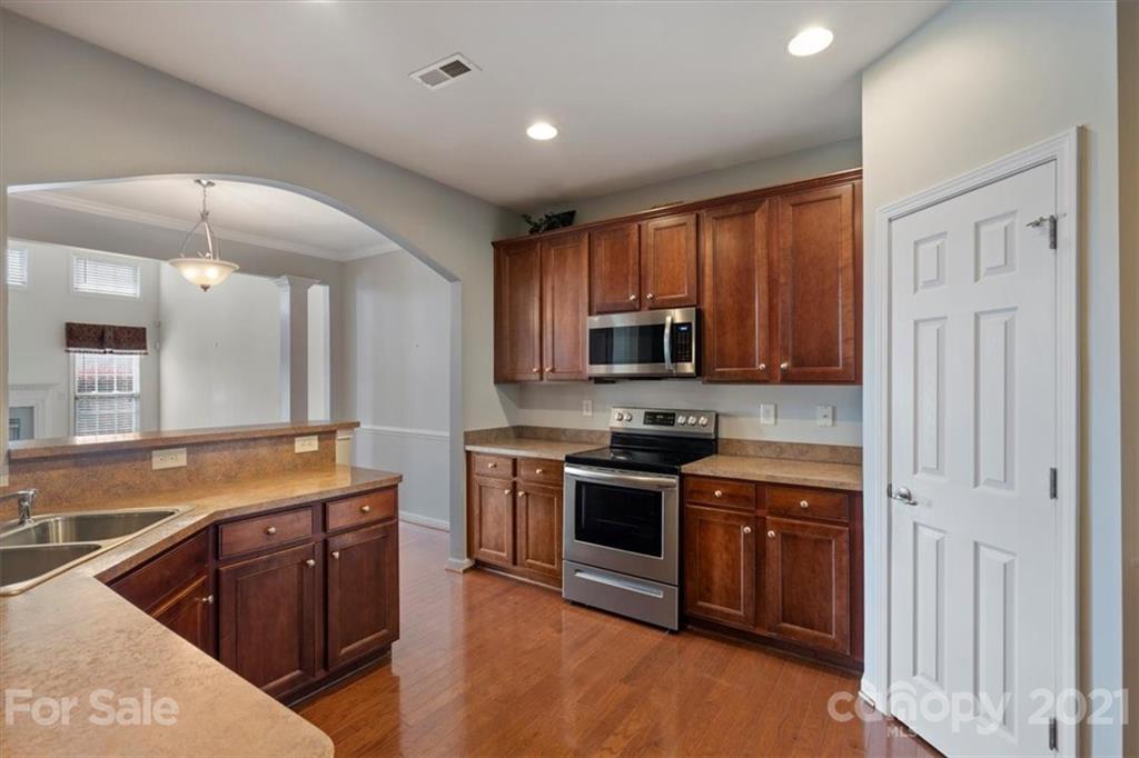 257 Garnet Court Fort Mill, SC 29708 - Photo 19 of 43 a kitchen with stainless steel appliances granite countertop a stove a sink and a microwave