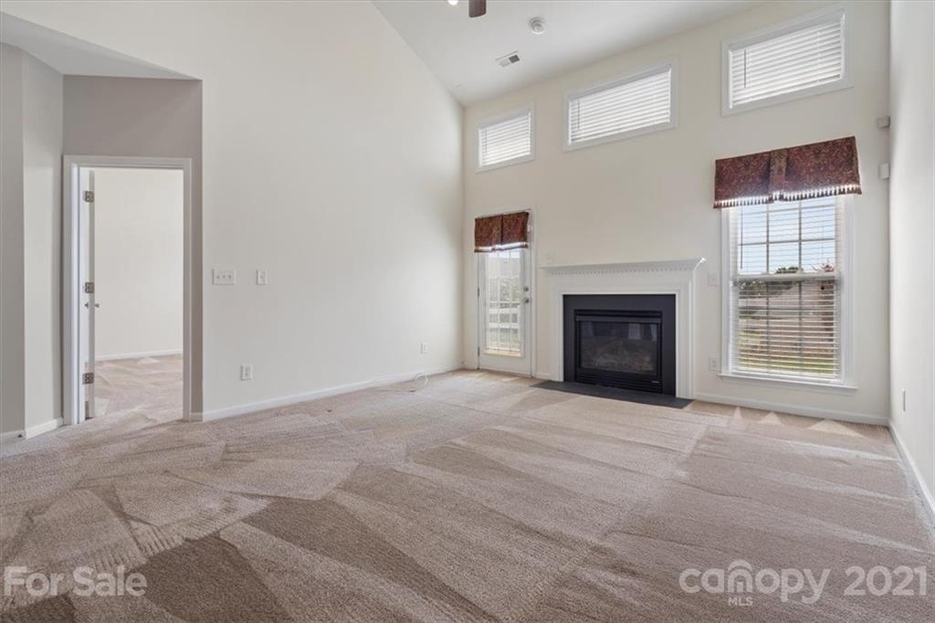 257 Garnet Court Fort Mill, SC 29708 - Photo 24 of 43 a view of an empty room with a fireplace and a window
