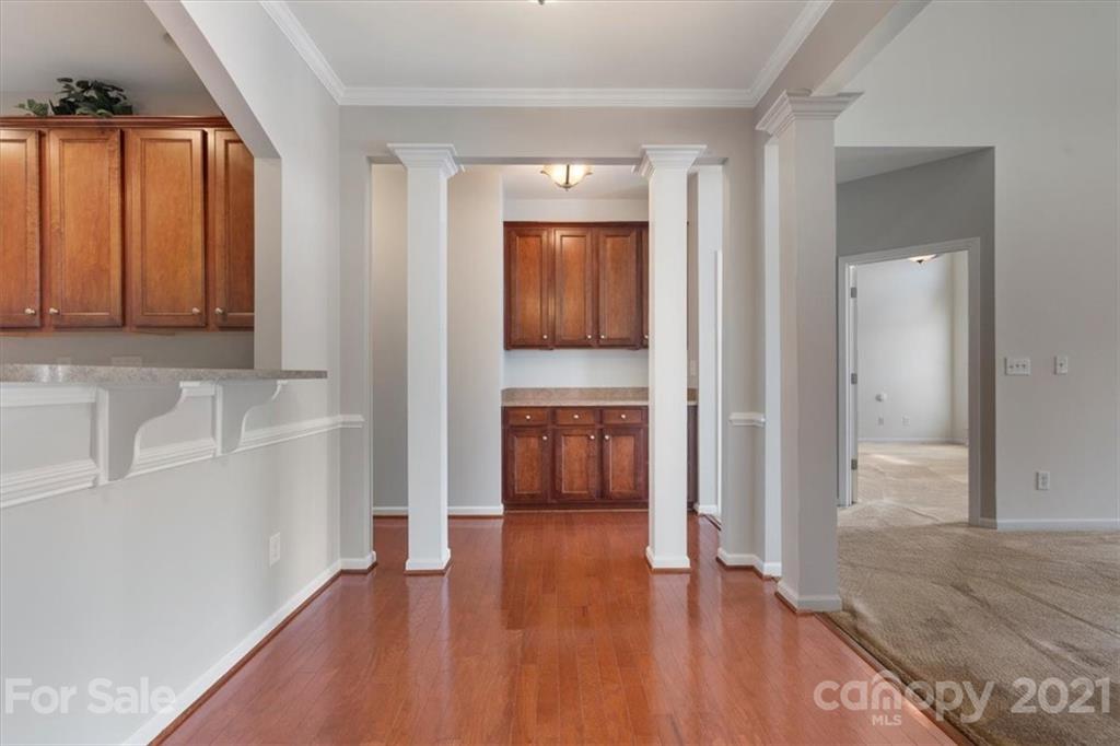 257 Garnet Court Fort Mill, SC 29708 - Photo 25 of 43 a view of a hallway with wooden floor and a cabinet