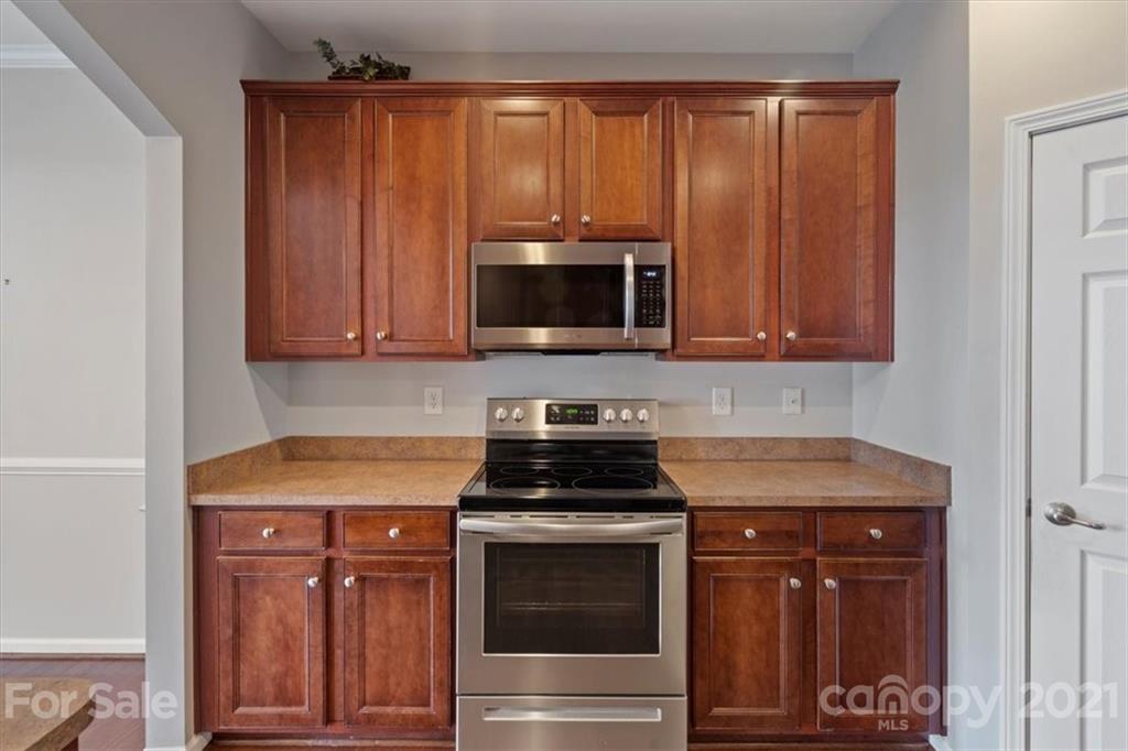 257 Garnet Court Fort Mill, SC 29708 - Photo 6 of 43 a kitchen with granite countertop a stove and a microwave