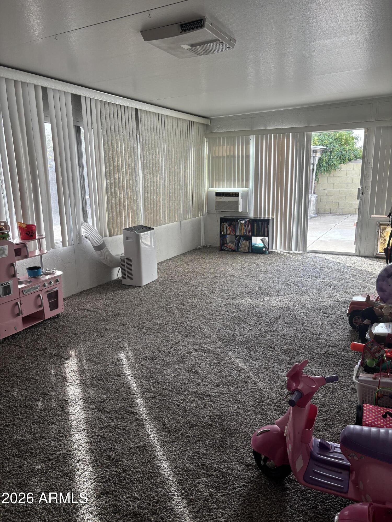 4151 West Shaw Butte Drive Phoenix, AZ 85029 - Photo 12 of 17 a living room with furniture and a floor to ceiling window