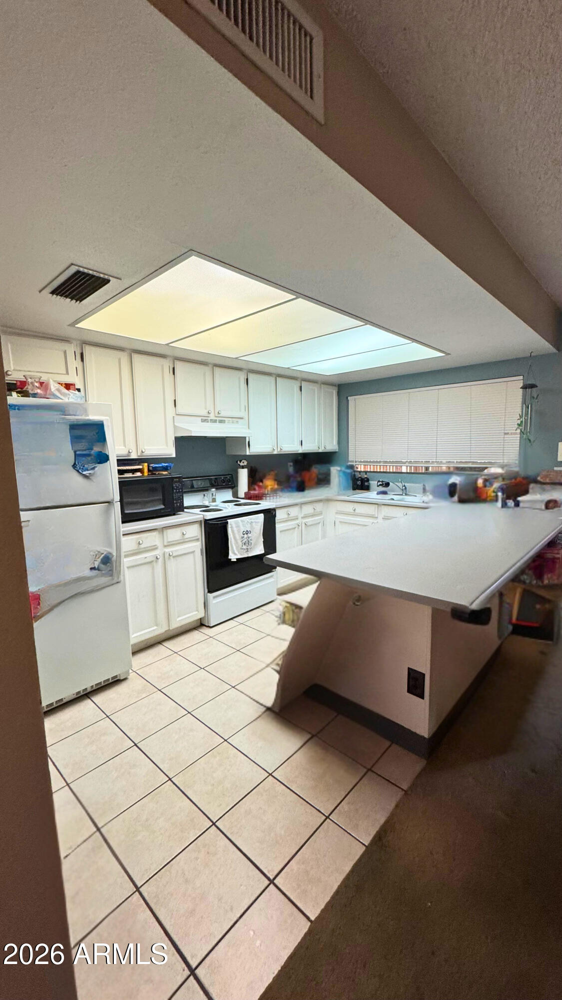 4151 West Shaw Butte Drive Phoenix, AZ 85029 - Photo 5 of 17 a kitchen with stainless steel appliances granite countertop a sink counter space cabinets and a stove