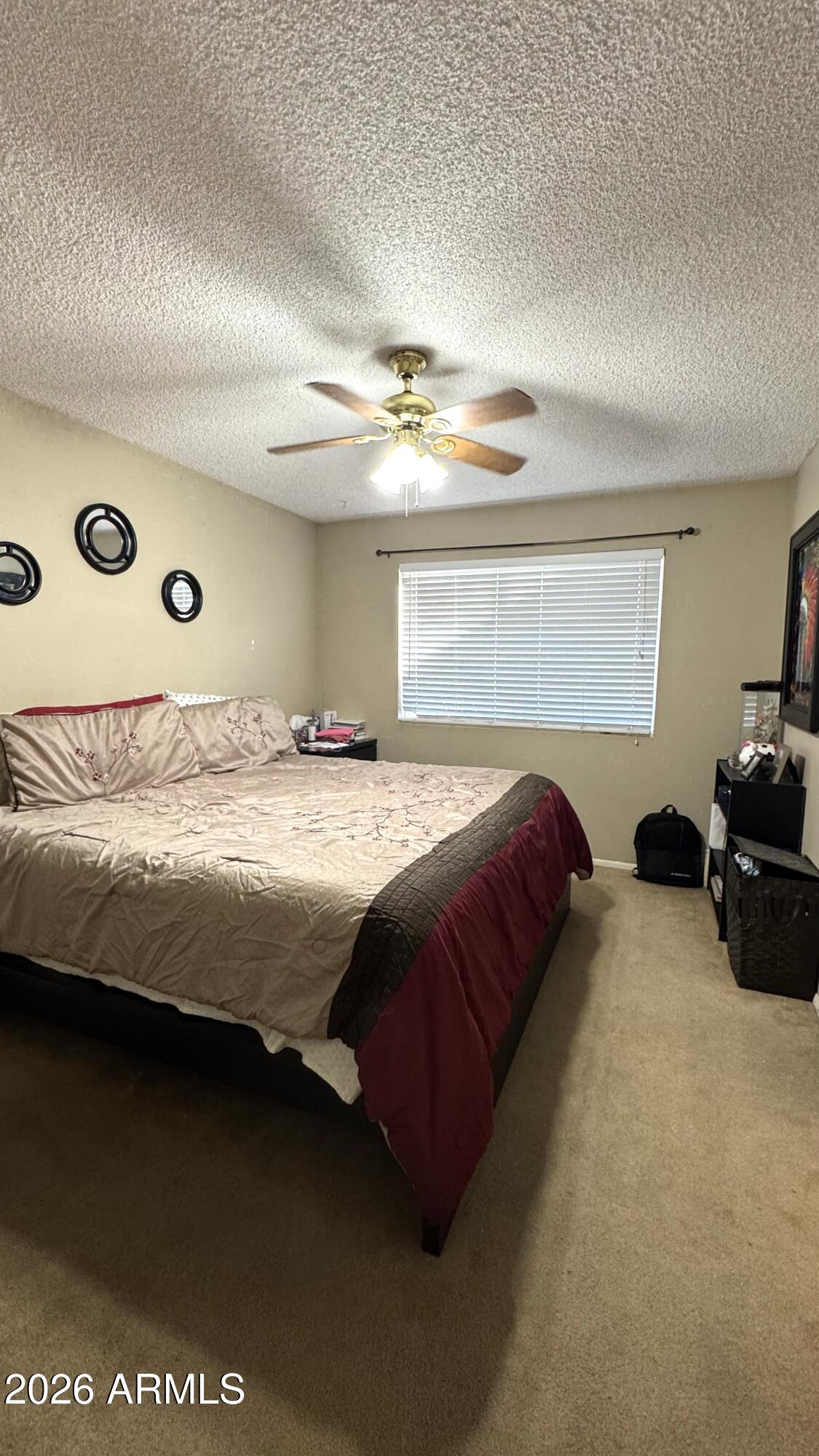 4151 West Shaw Butte Drive Phoenix, AZ 85029 - Photo 6 of 17 a bedroom with a bed and a ceiling fan