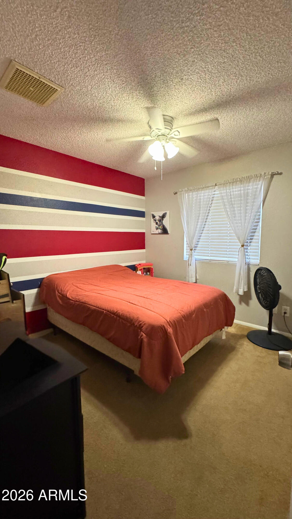 4151 West Shaw Butte Drive Phoenix, AZ 85029 - Photo 8 of 17 a bedroom with a bed and a chandelier