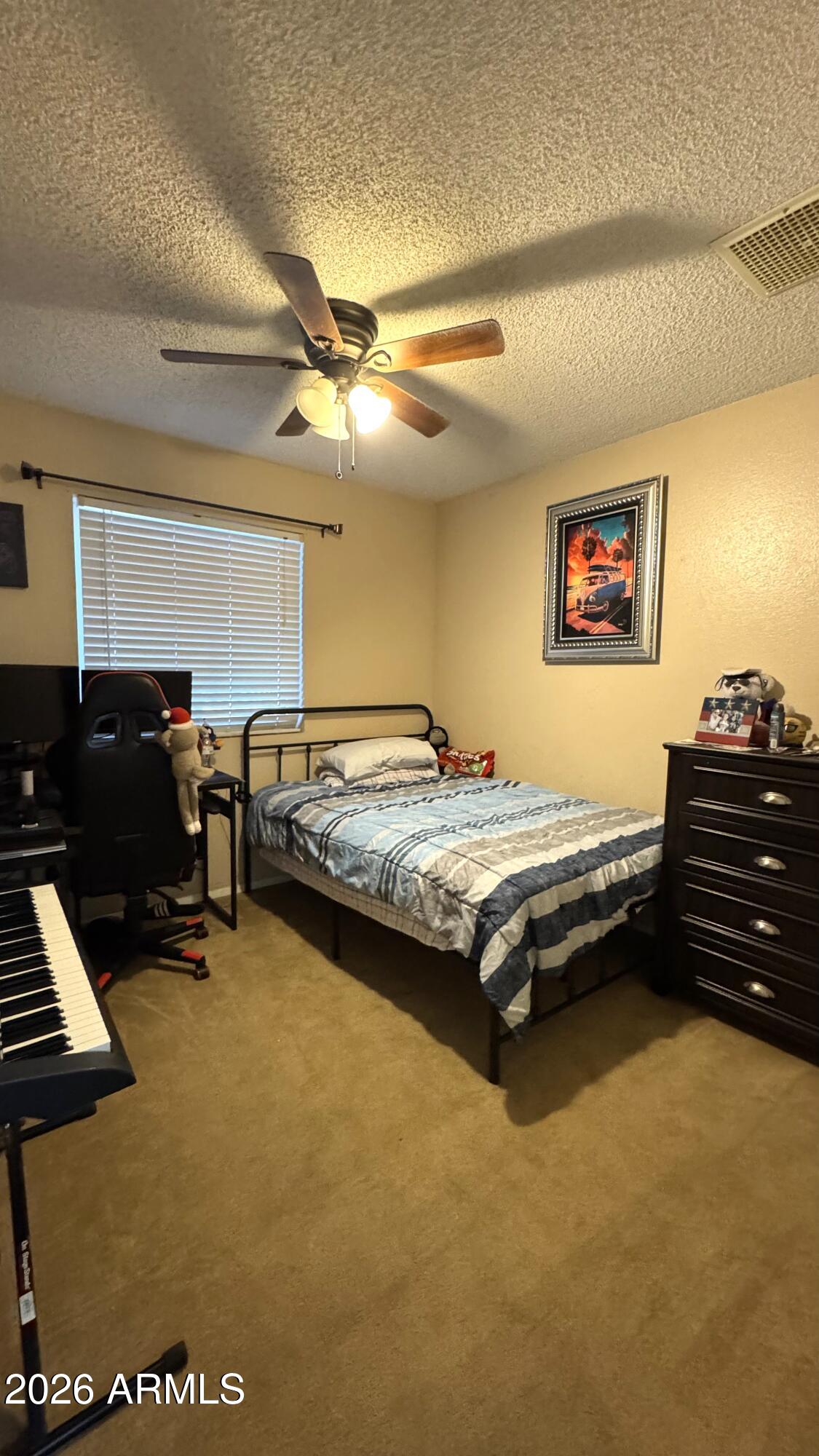 4151 West Shaw Butte Drive Phoenix, AZ 85029 - Photo 10 of 17 a spacious bedroom with a bed and a desk
