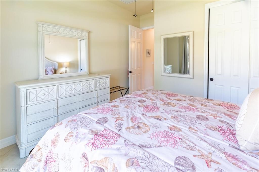 9372 Vercelli Court Naples, FL 34113 - Photo 28 of 50 Bedroom featuring a closet and tile patterned flooring