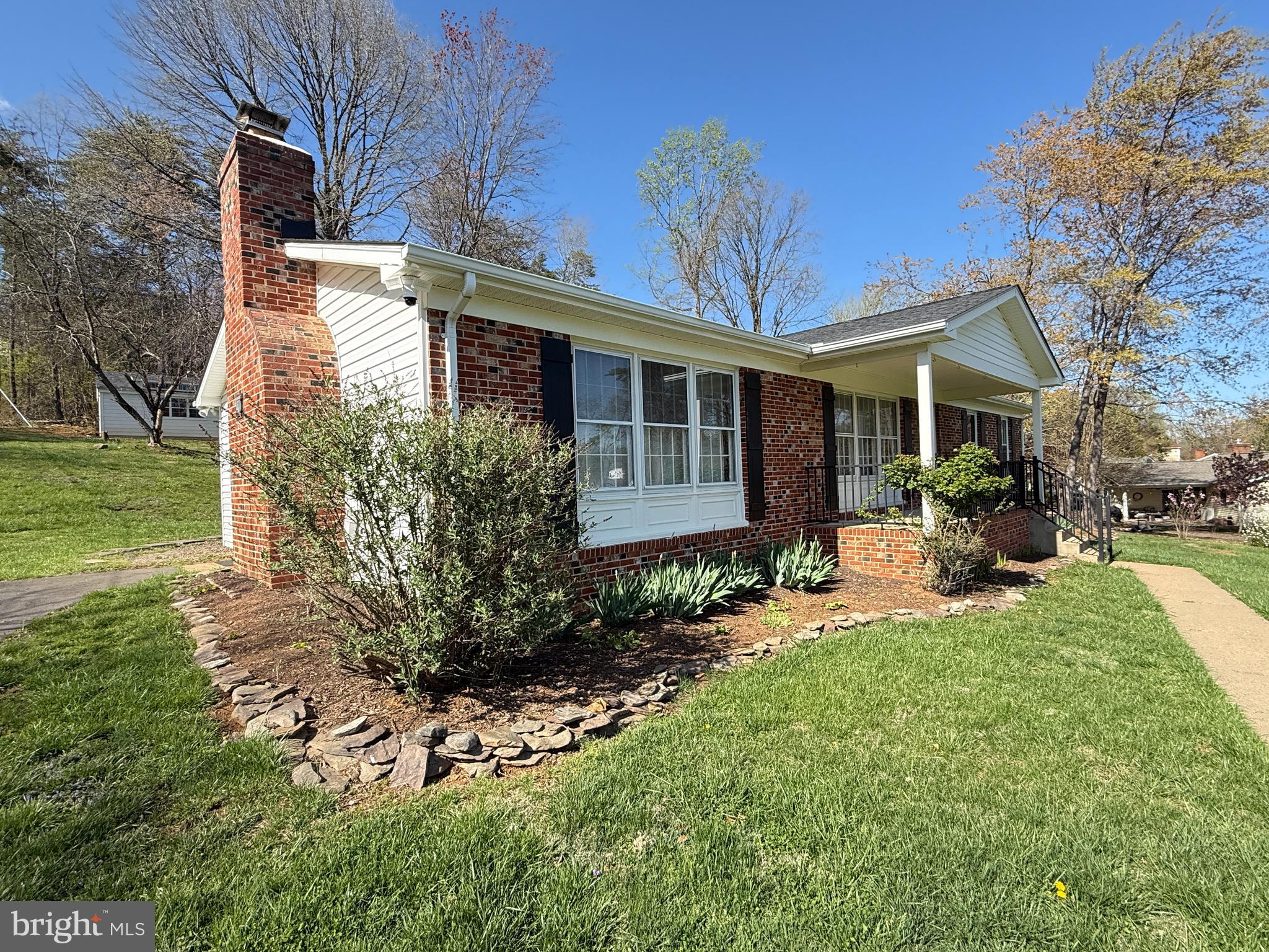 a view of a house with backyard sitting area and garden