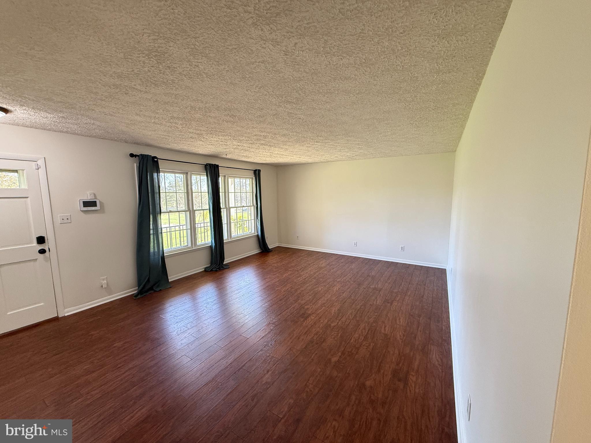 5572 Old Bust Head Road Broad Run, VA 20137 - Photo 11 of 30 wooden floor in an empty room with a window