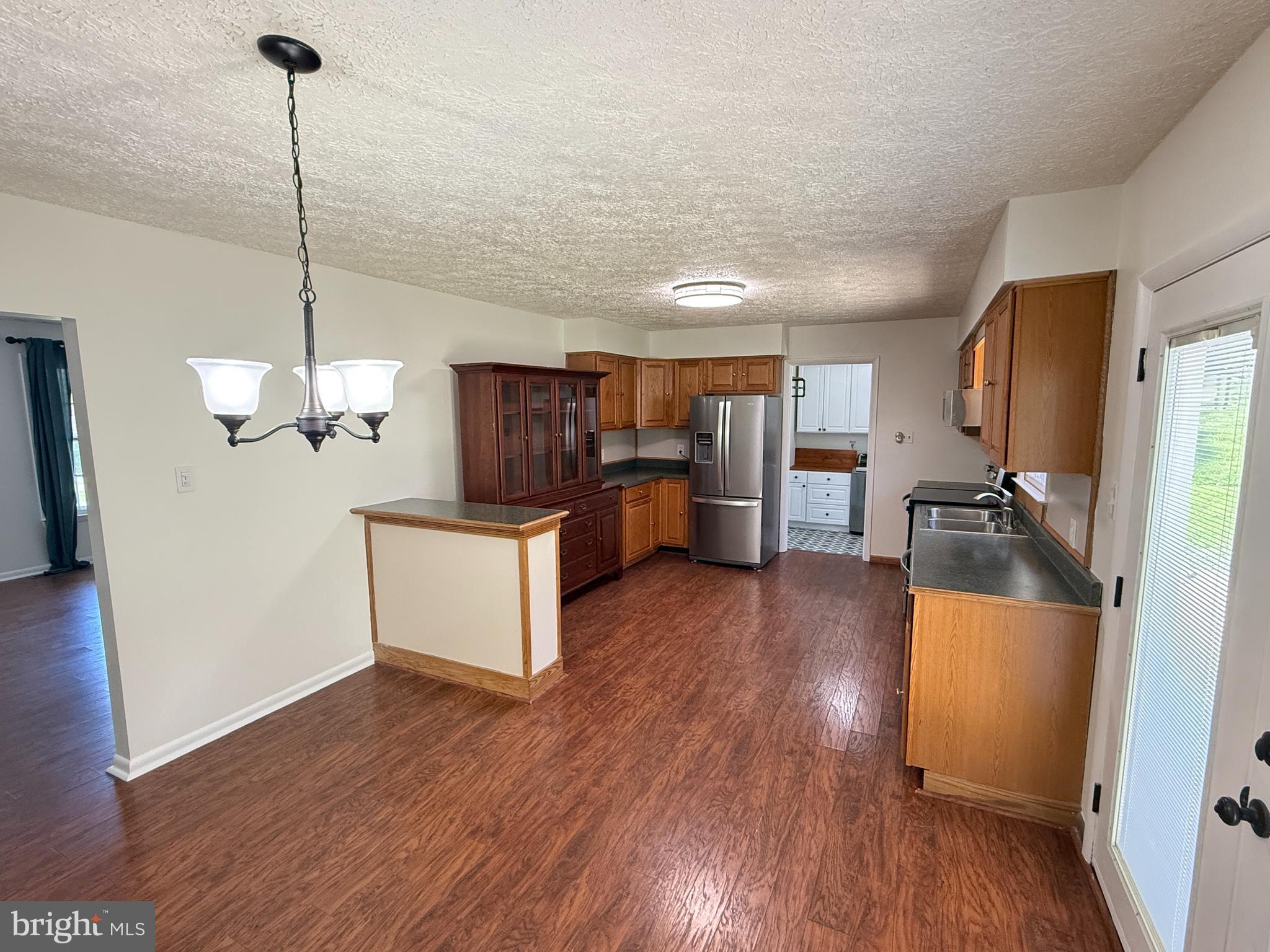 5572 Old Bust Head Road Broad Run, VA 20137 - Photo 13 of 30 a kitchen with stainless steel appliances granite countertop a refrigerator a sink dishwasher a stove and a wooden floor