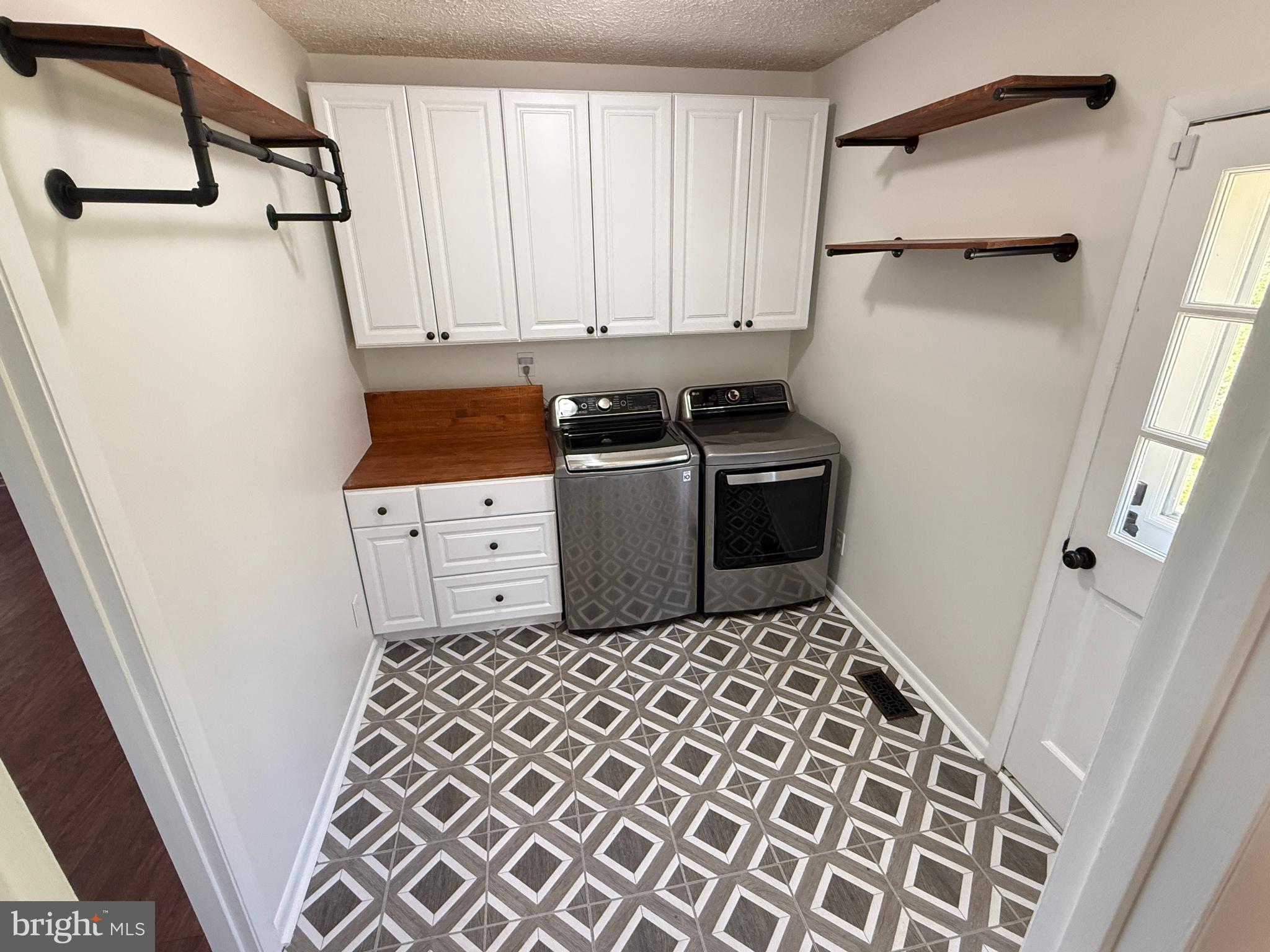 5572 Old Bust Head Road Broad Run, VA 20137 - Photo 15 of 30 a utility room with cabinets washer and dryer