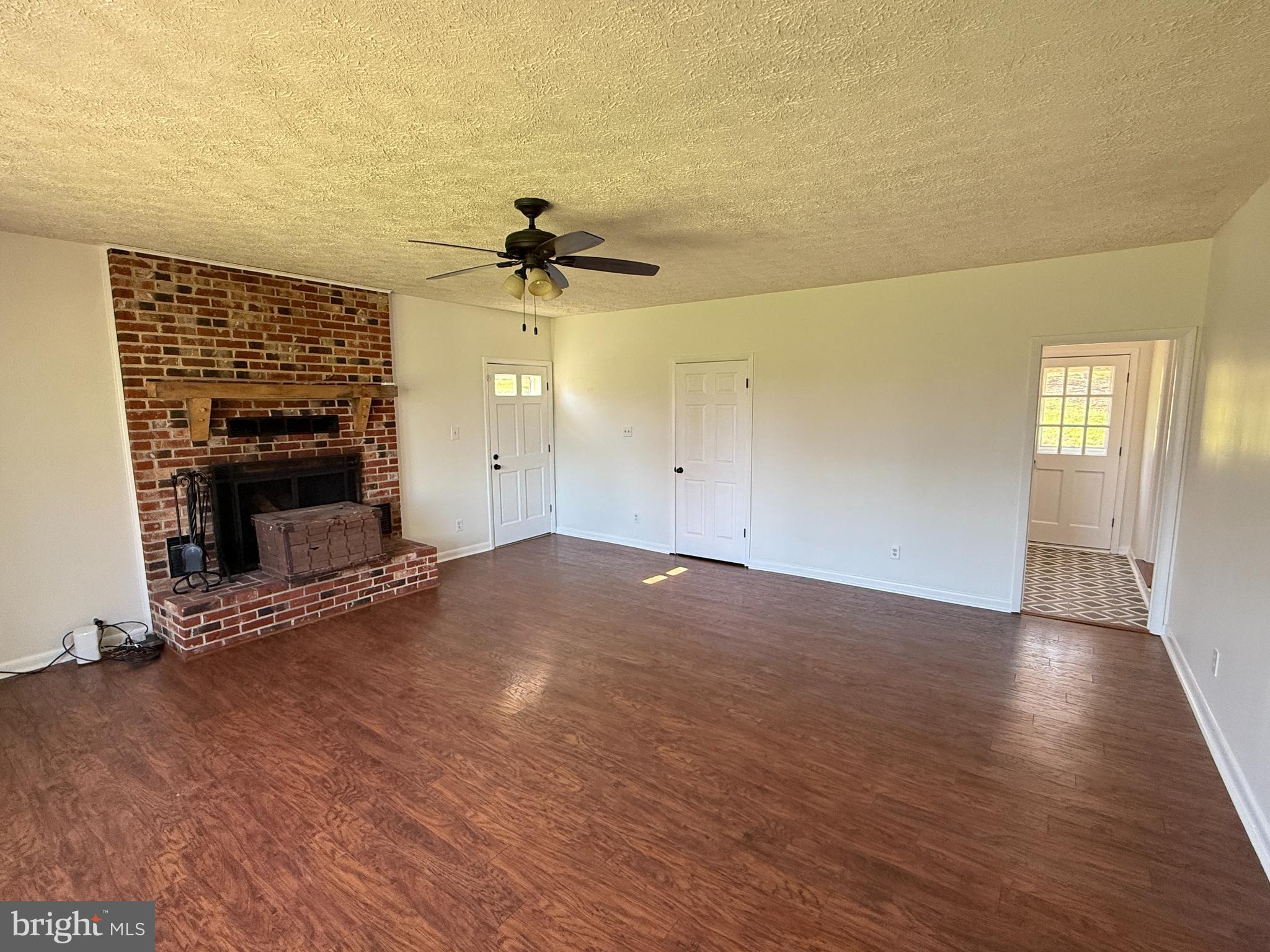 5572 Old Bust Head Road Broad Run, VA 20137 - Photo 16 of 30 an empty room with windows and fireplace
