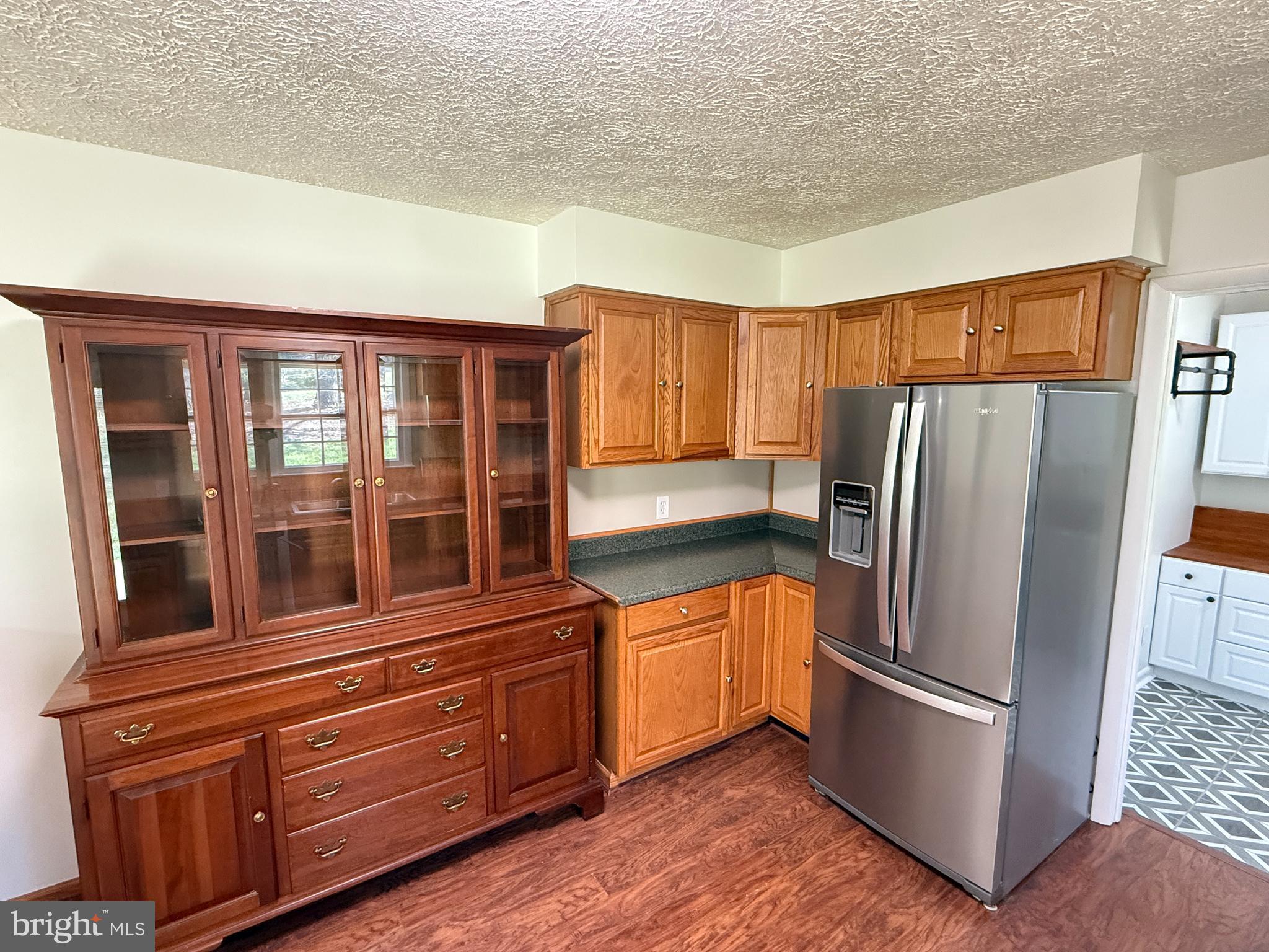 5572 Old Bust Head Road Broad Run, VA 20137 - Photo 18 of 30 a kitchen with stainless steel appliances granite countertop a refrigerator and a stove top oven