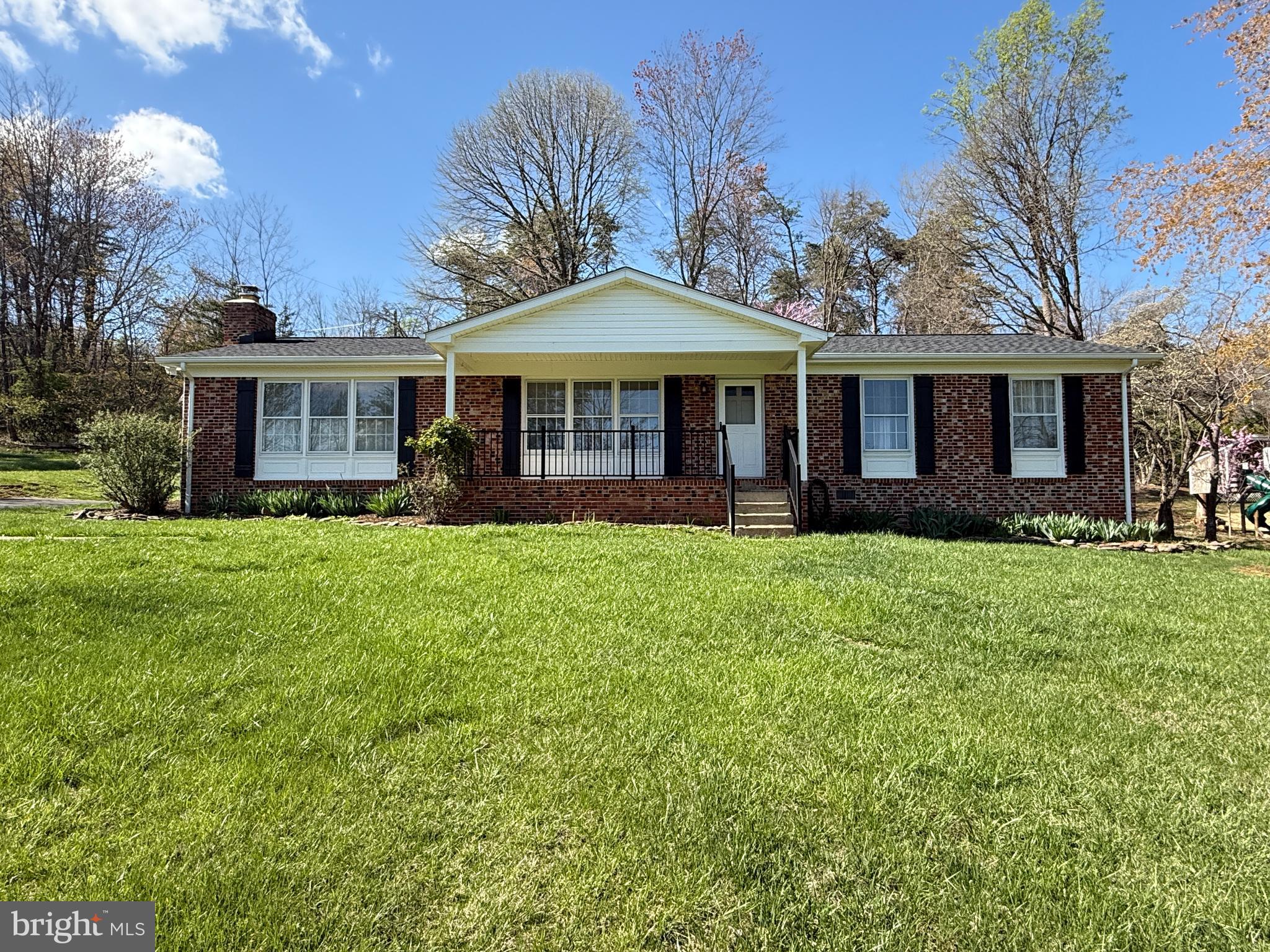 5572 Old Bust Head Road Broad Run, VA 20137 - Photo 2 of 30 a front view of a house with a garden and trees
