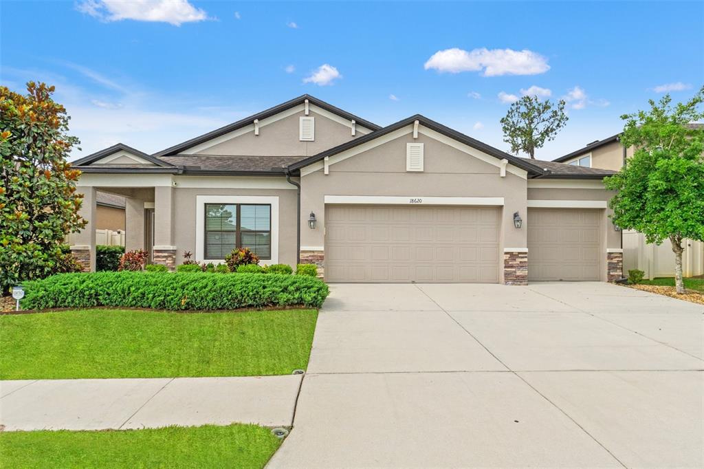 18620 Rococo Road Spring Hill, FL 34610 - Photo 1 of 1 a front view of house with yard and green space