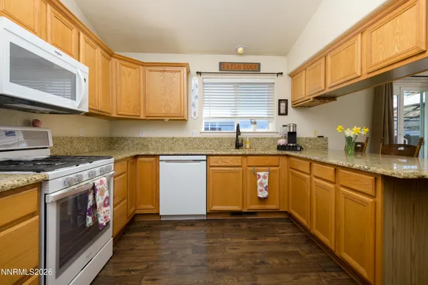 a kitchen with stainless steel appliances granite countertop a sink stove and cabinets
