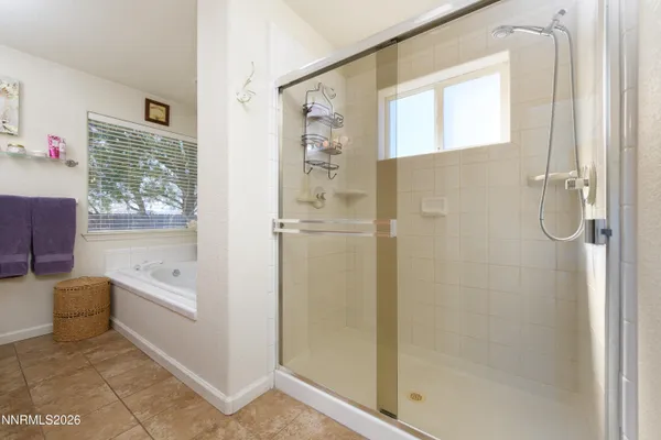 a bathroom with a tub shower and sink