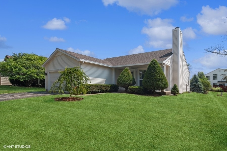 115 Periwinkle Lane Bolingbrook, IL 60490 - Photo 1 of 15 a view of a house with a yard and plants