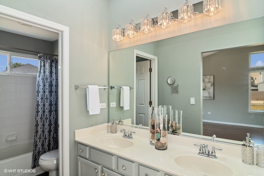 115 Periwinkle Lane Bolingbrook, IL 60490 - Photo 11 of 15 a bathroom with a sink vanity granite and a mirror