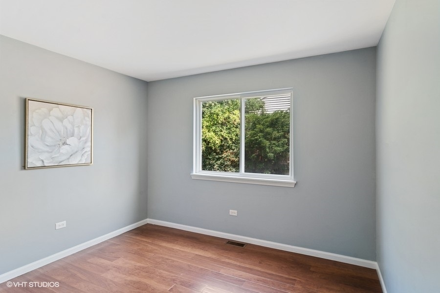 115 Periwinkle Lane Bolingbrook, IL 60490 - Photo 13 of 15 a view of an empty room with wooden floor and a window
