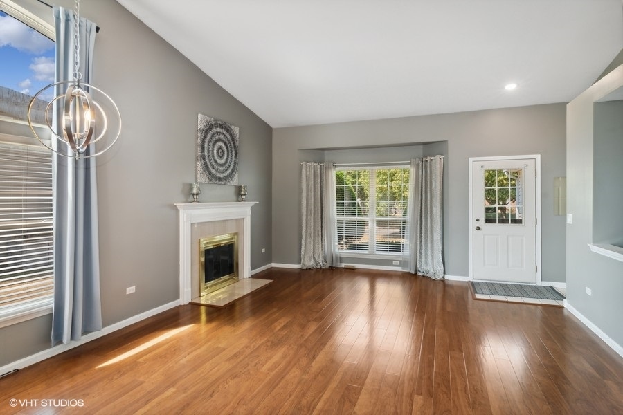 115 Periwinkle Lane Bolingbrook, IL 60490 - Photo 2 of 15 a view of empty room with wooden floor and fireplace