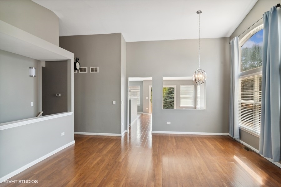 115 Periwinkle Lane Bolingbrook, IL 60490 - Photo 4 of 15 a view of an empty room with wooden floor and a window