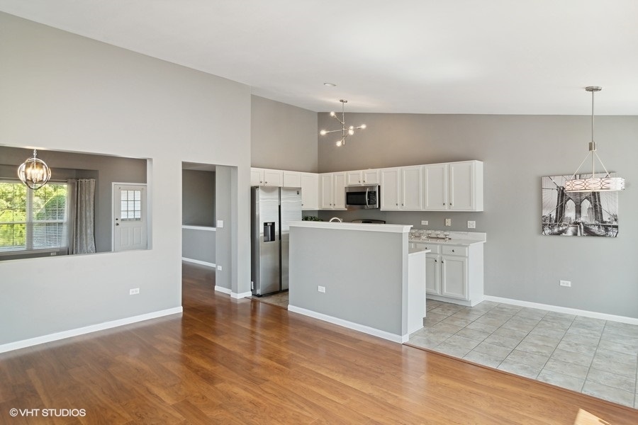 115 Periwinkle Lane Bolingbrook, IL 60490 - Photo 8 of 15 a view of kitchen with stainless steel appliances refrigerator stove top oven and cabinets