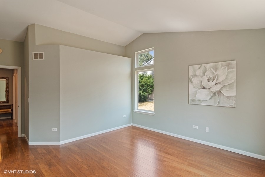 115 Periwinkle Lane Bolingbrook, IL 60490 - Photo 9 of 15 an empty room with wooden floor and window
