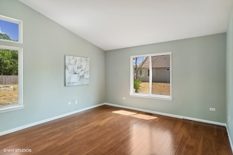 115 Periwinkle Lane Bolingbrook, IL 60490 - Photo 10 of 15 a view of an empty room with wooden floor and a window