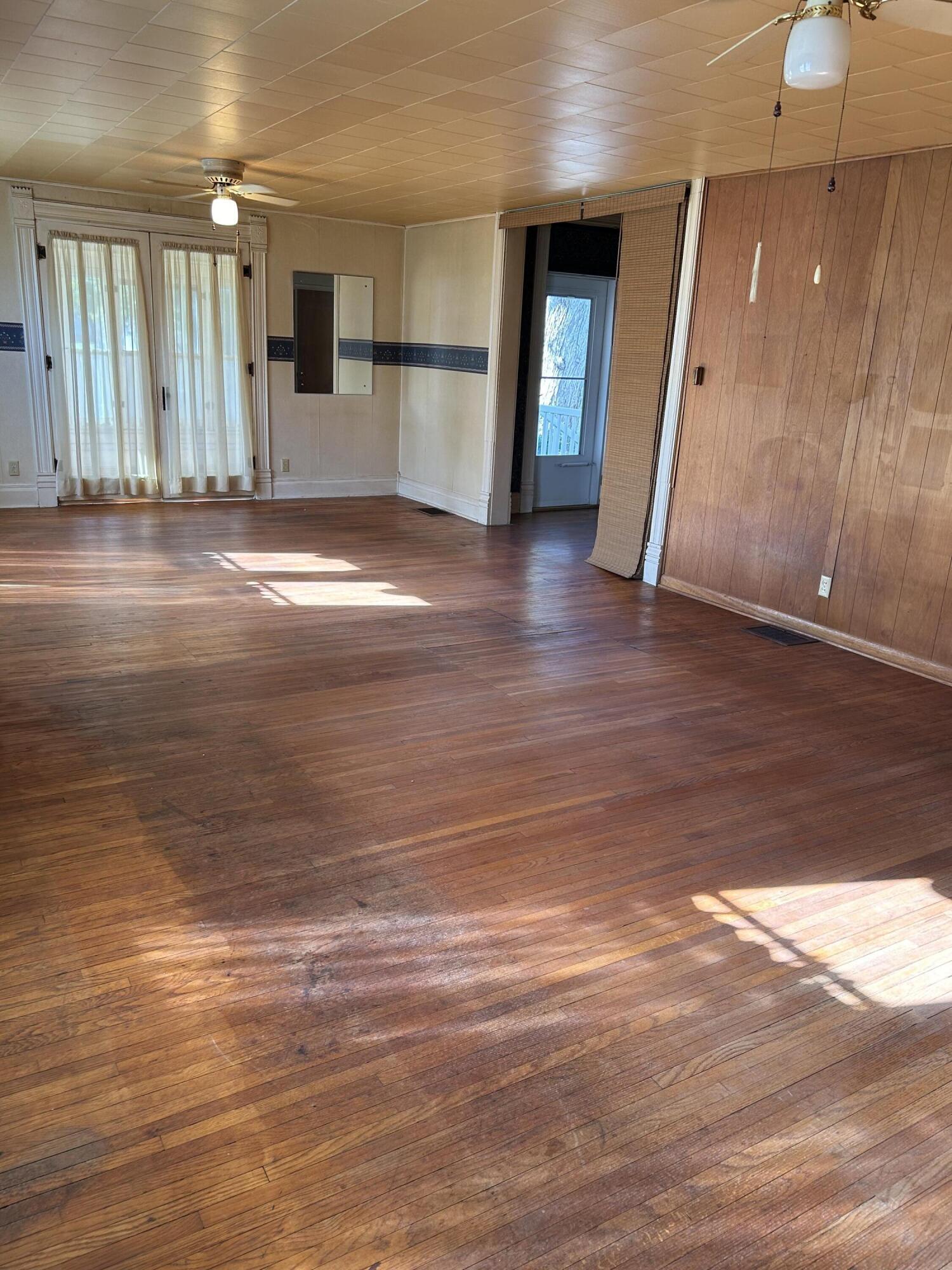 617 North Abigail Street Rensselaer, IN 47978 - Photo 5 of 44 a view of a hallway with wooden floor and a kitchen
