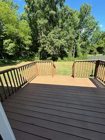 708 Hampton Street Iva, SC 29655 - Photo 4 of 14 This spacious outdoor deck overlooks a verdant lawn, offering an inviting space for relaxation and enjoyment.