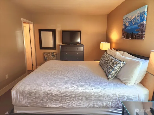 a bedroom with a bed and a television