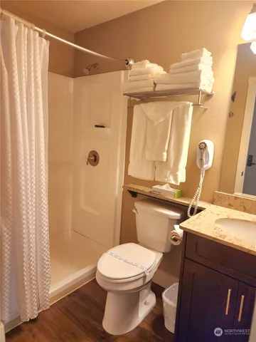 a bathroom with a toilet and shower