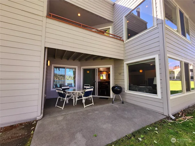 a view of a house with patio and a yard