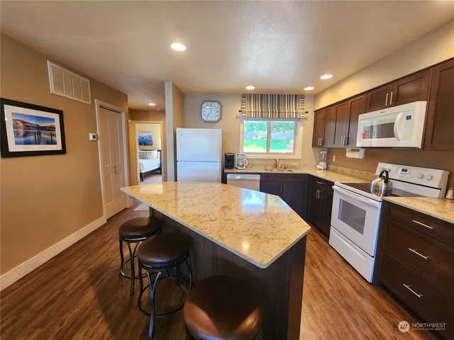 a kitchen with a table chairs sink and cabinets