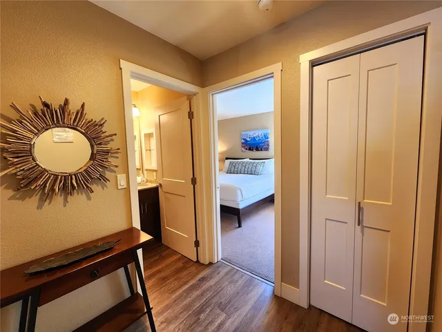 a view of a room that has a bed and a chandelier