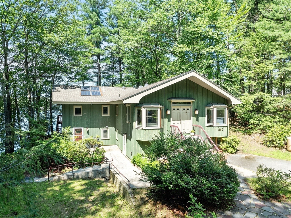 260 Fort Pond Road Lancaster, MA 01523 - Photo 3 of 41 a front view of a house with a yard