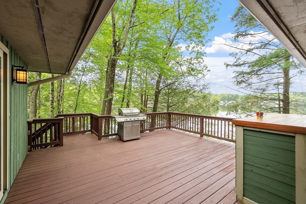 260 Fort Pond Road Lancaster, MA 01523 - Photo 5 of 41 a view of a patio with a table chairs and wooden floor