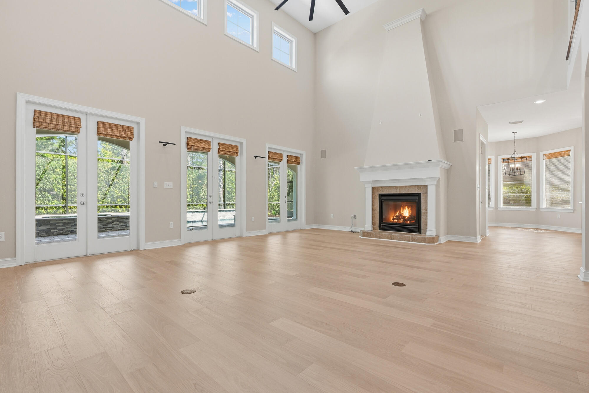413 Sea Winds Drive Santa Rosa Beach, FL 32459 - Photo 8 of 65 a view of an empty room with wooden floor fireplace and a window