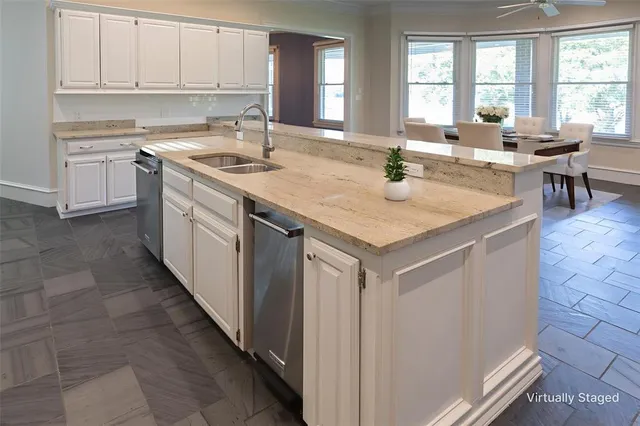 a kitchen with stainless steel appliances granite countertop a sink stove and cabinets