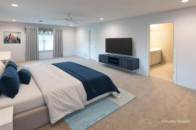 a bedroom with a bed and a television