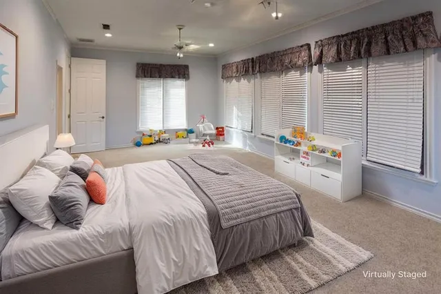 a bedroom with a bed a window and couch