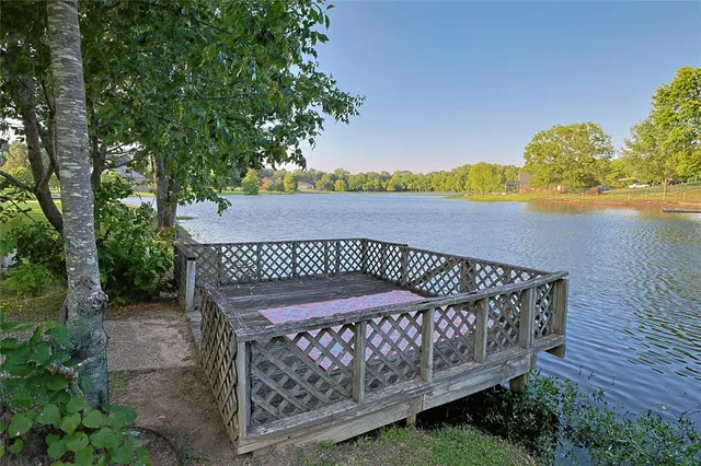 a view of a wooden deck with a yard