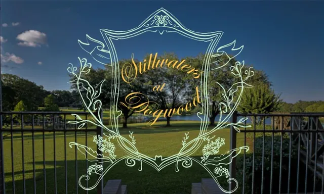 a sign on a wall next to a lake