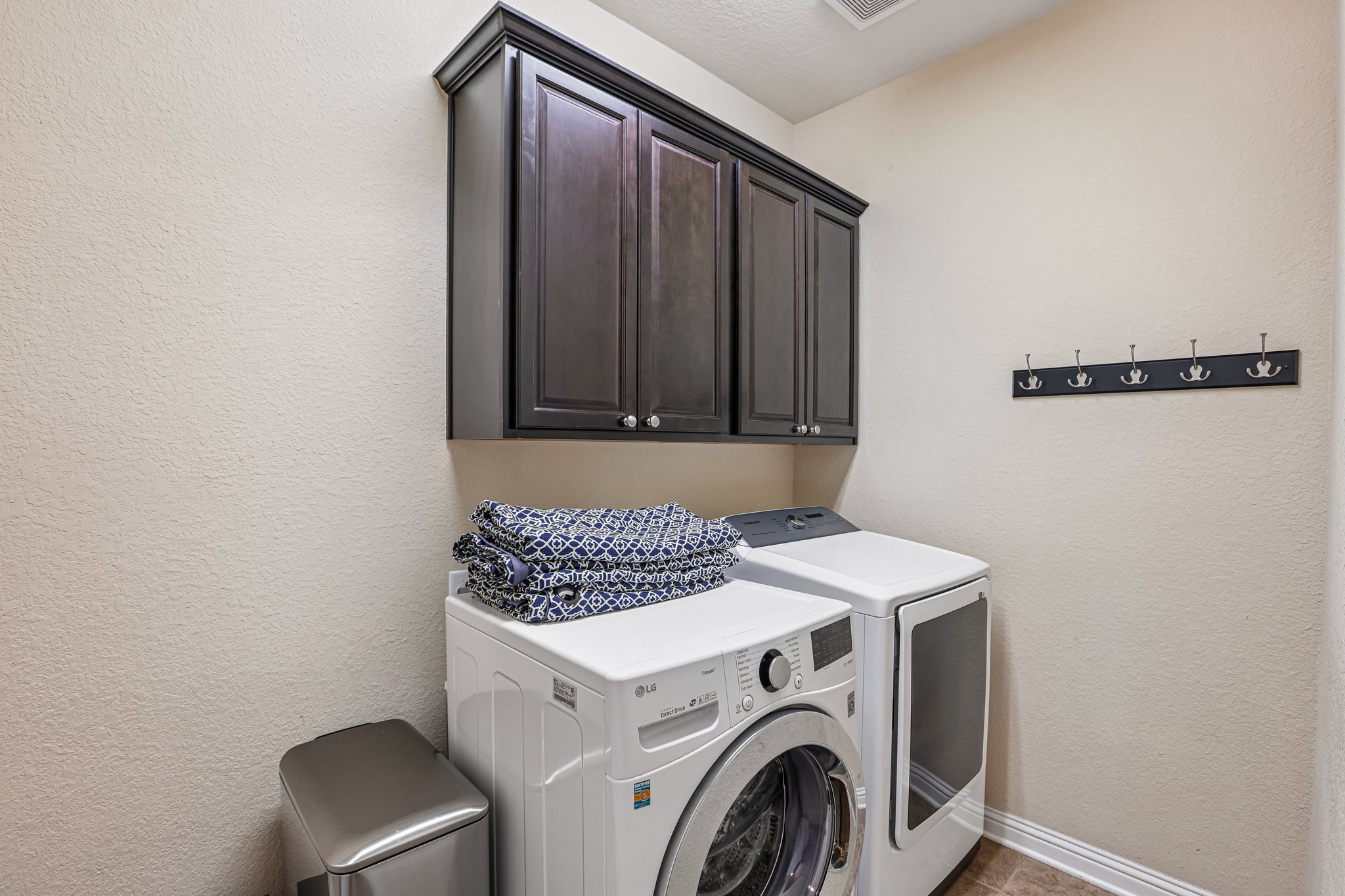 1924 Granite Springs Road Leander, TX 78641 - Photo 31 of 36 Streamlined laundry room features practical storage with wall-mounted cabinetry.