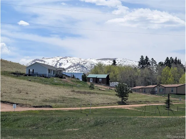 a view of a town with barn in the background