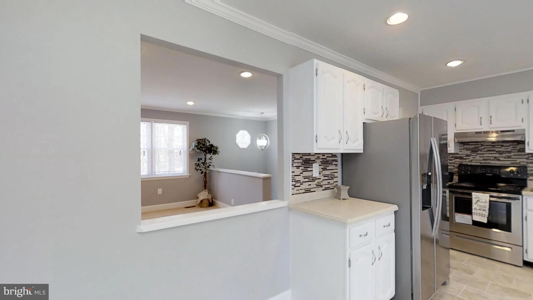 7764 Telegraph Road Severn, MD 21144 - Photo 12 of 24 a kitchen with stainless steel appliances a refrigerator and a stove top oven