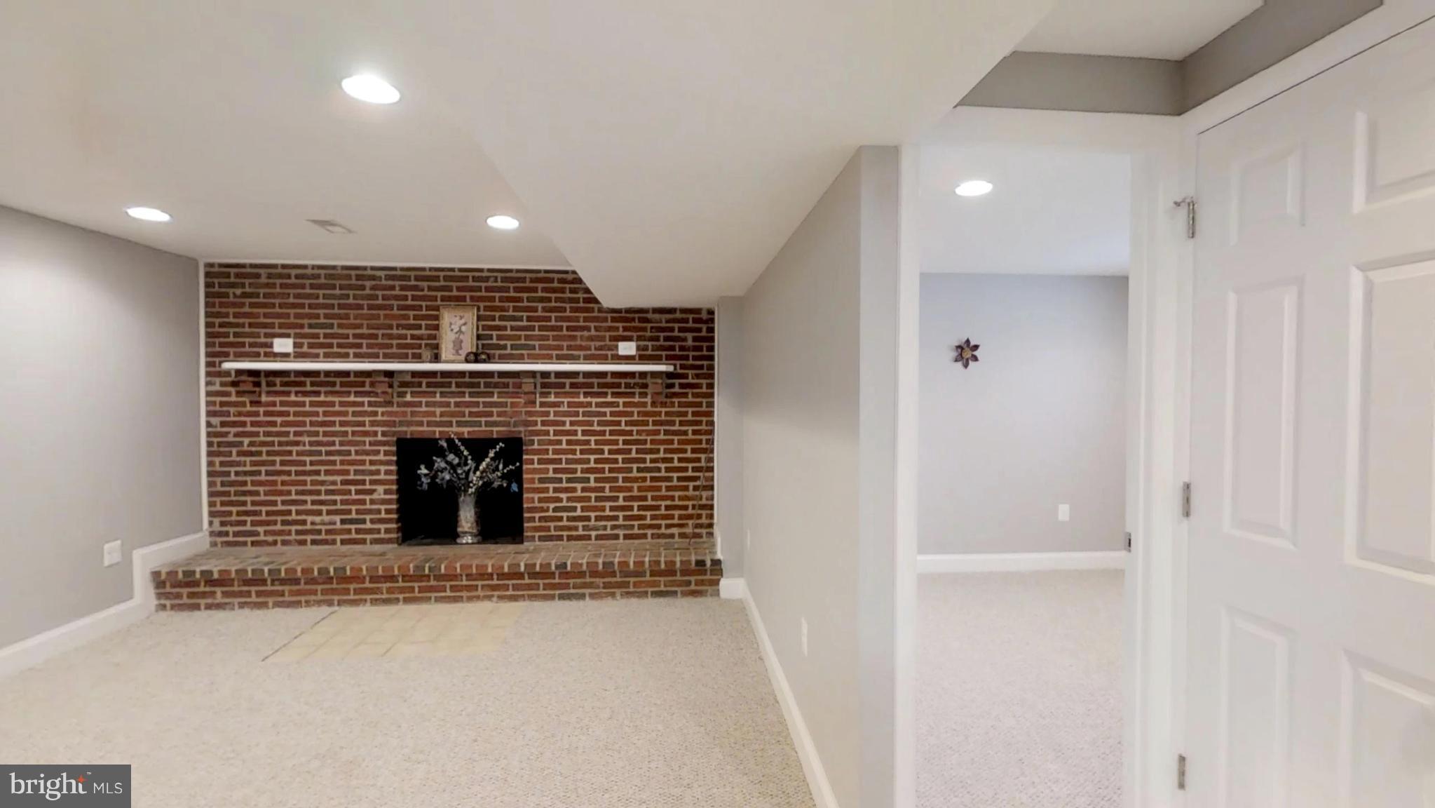 7764 Telegraph Road Severn, MD 21144 - Photo 13 of 24 a view of an empty room with a fireplace