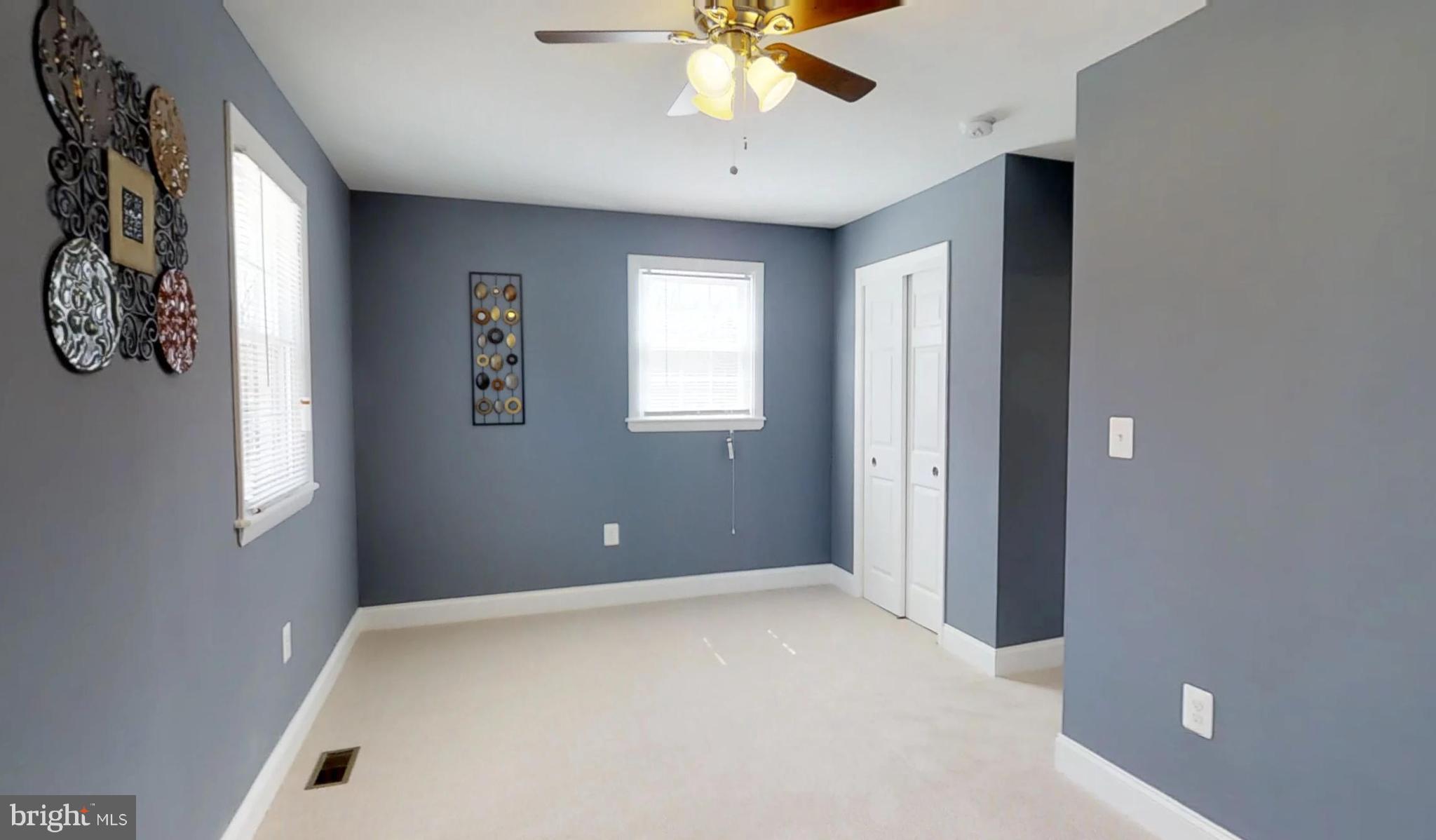 7764 Telegraph Road Severn, MD 21144 - Photo 19 of 24 a view of a livingroom with a window and a ceiling fan