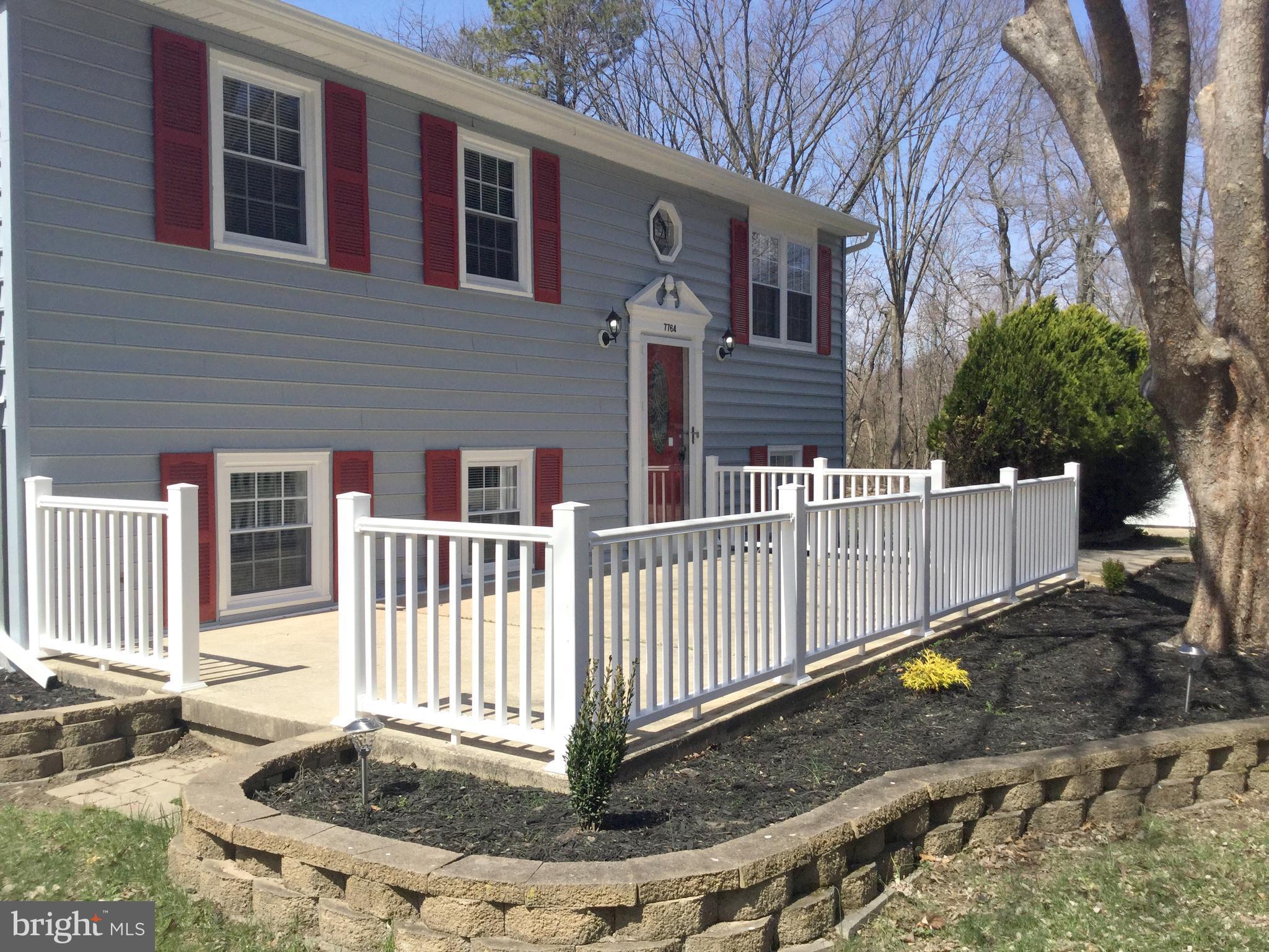 7764 Telegraph Road Severn, MD 21144 - Photo 23 of 24 a view of a house with a small yard and wooden fence